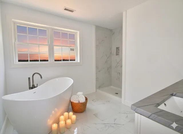 a bathroom with a bathtub and a sink