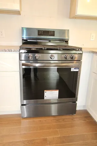 a stove top oven sitting inside of a kitchen