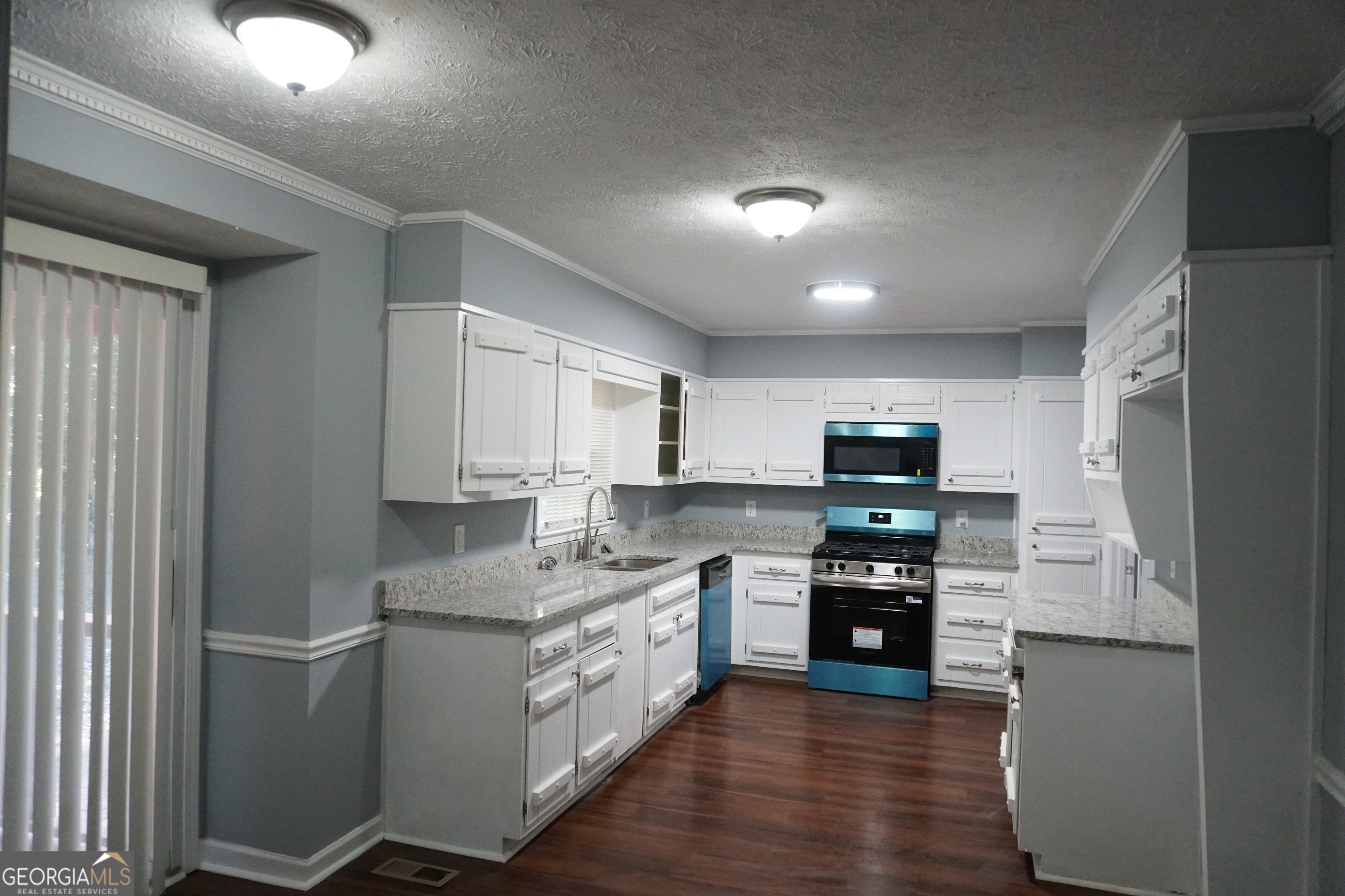 9243 Seminole Road Jonesboro, GA 30236 - Photo 11 of 40 a kitchen with stainless steel appliances granite countertop a refrigerator sink and stove