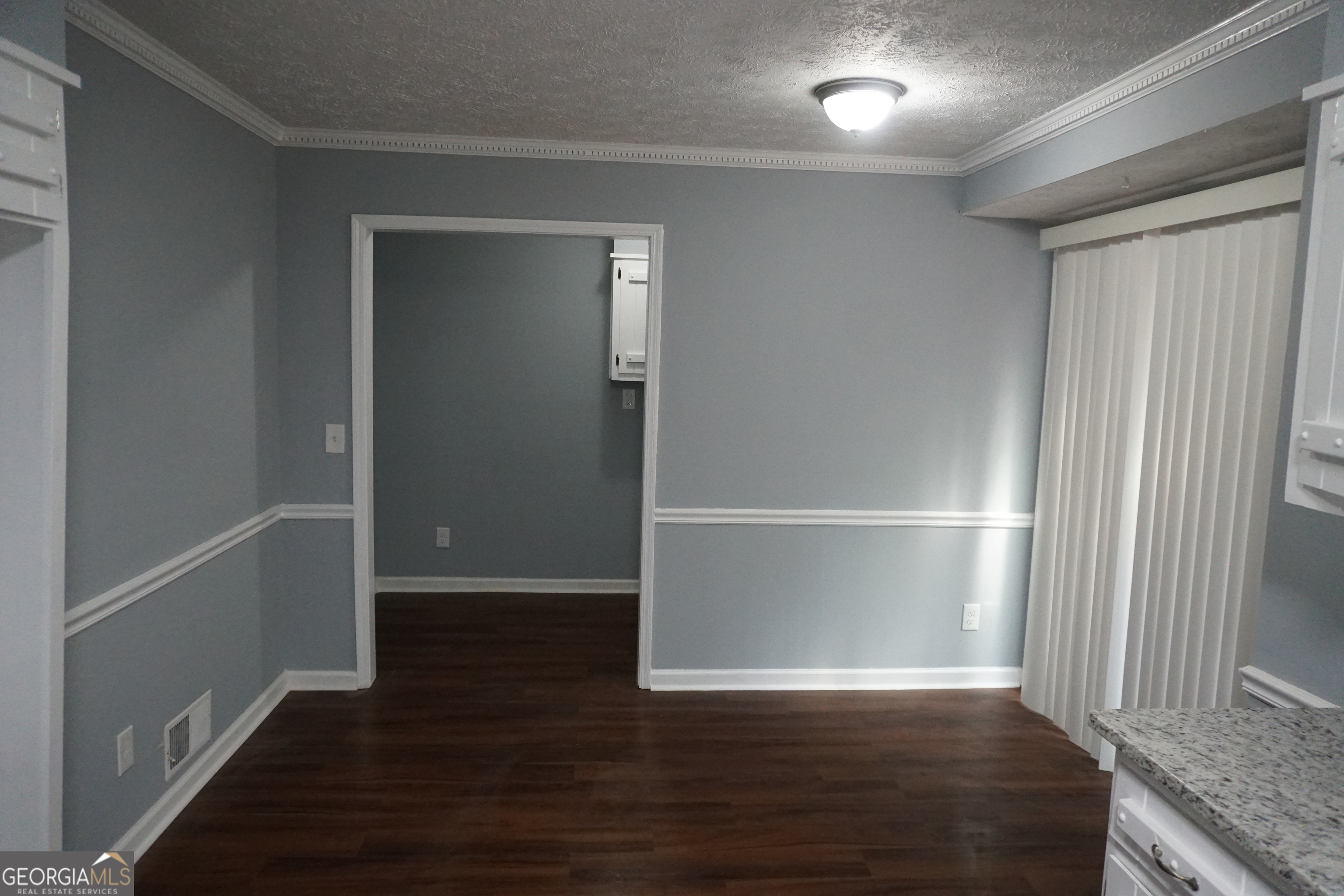 9243 Seminole Road Jonesboro, GA 30236 - Photo 12 of 40 a view of an empty room with wooden floor and a window