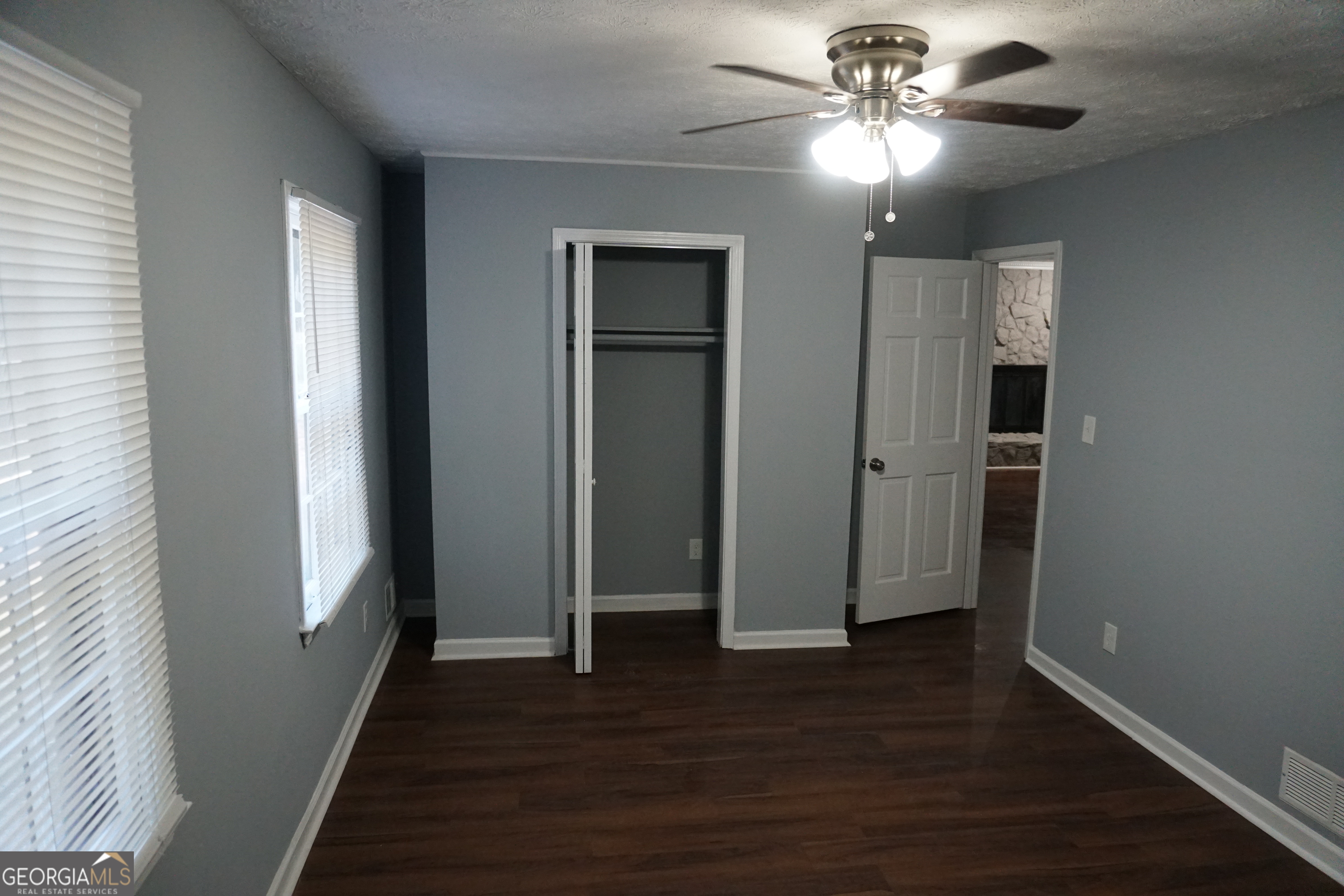 9243 Seminole Road Jonesboro, GA 30236 - Photo 20 of 40 wooden floor in an empty room with a window