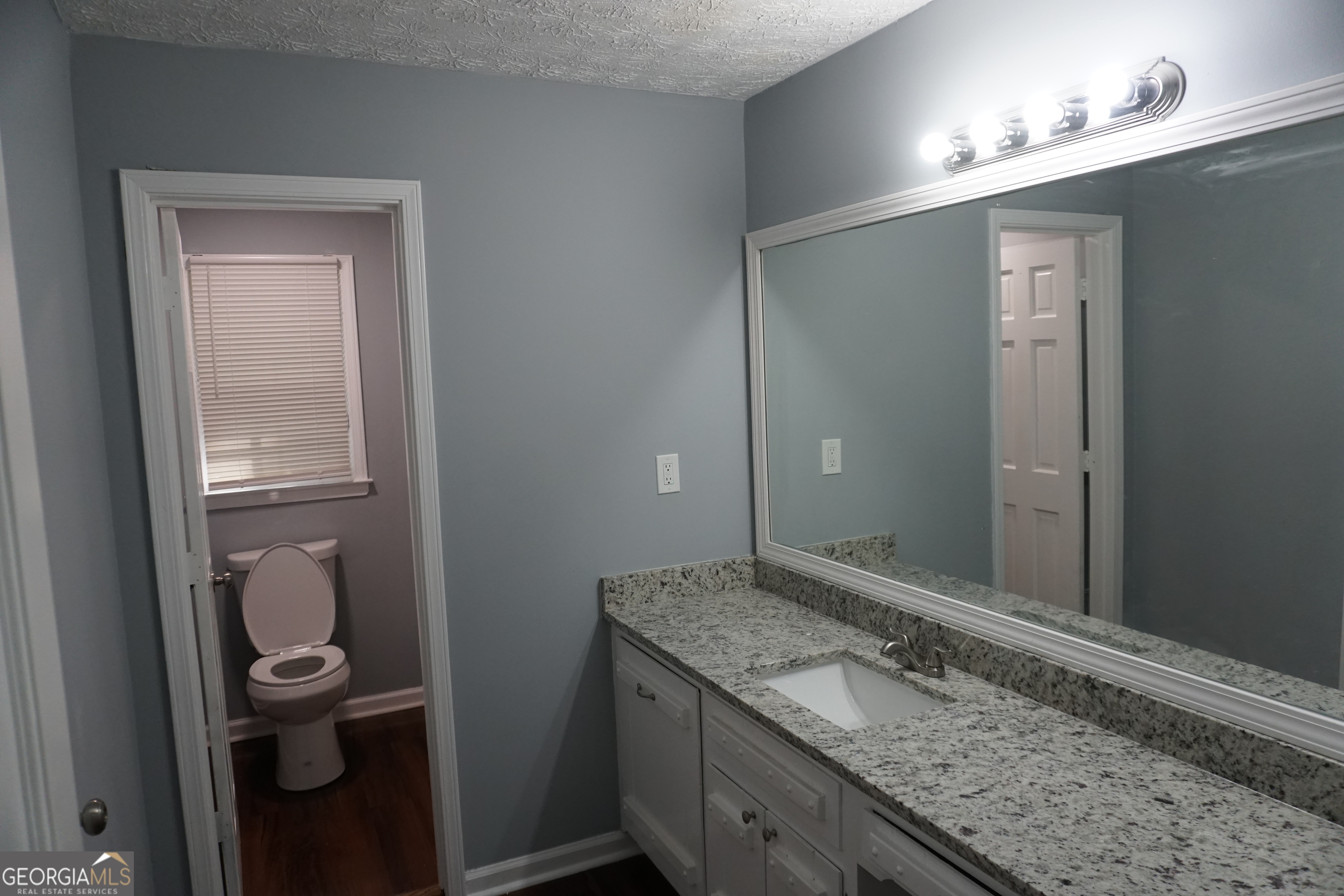 9243 Seminole Road Jonesboro, GA 30236 - Photo 24 of 40 a bathroom with a granite countertop sink and a mirror