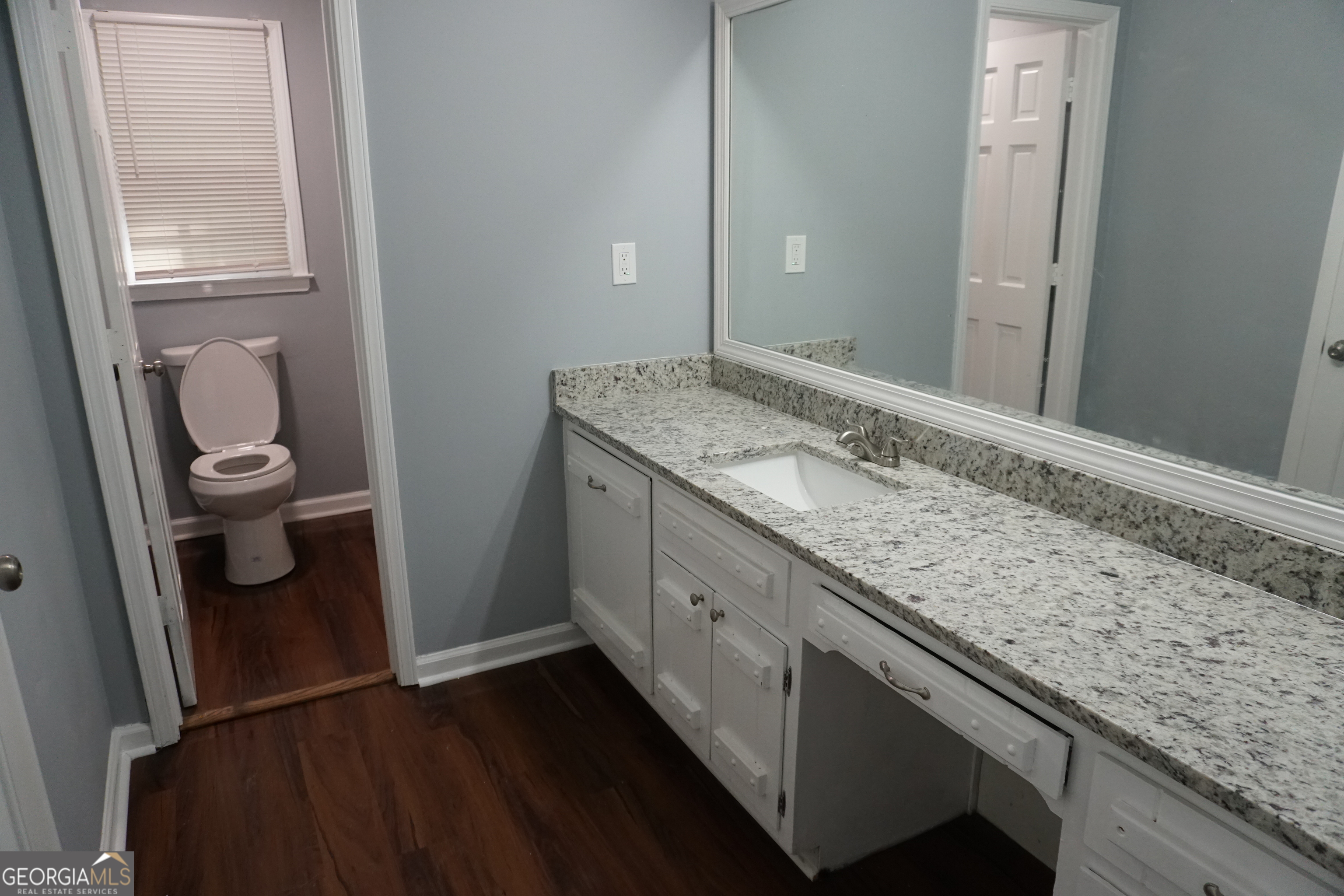 9243 Seminole Road Jonesboro, GA 30236 - Photo 25 of 40 a bathroom with a granite countertop sink and a mirror