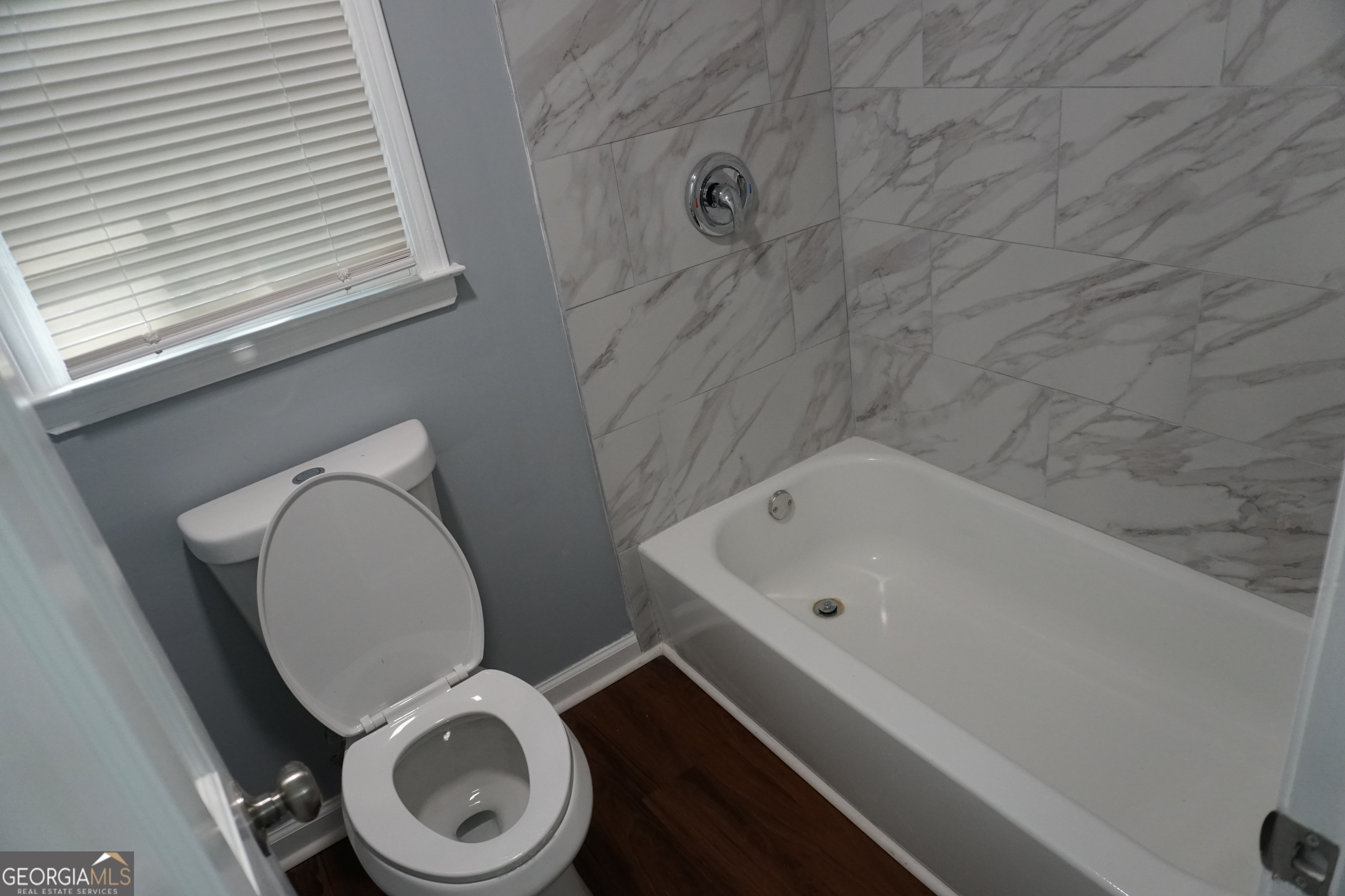 9243 Seminole Road Jonesboro, GA 30236 - Photo 26 of 40 a bathroom with a toilet and a sink