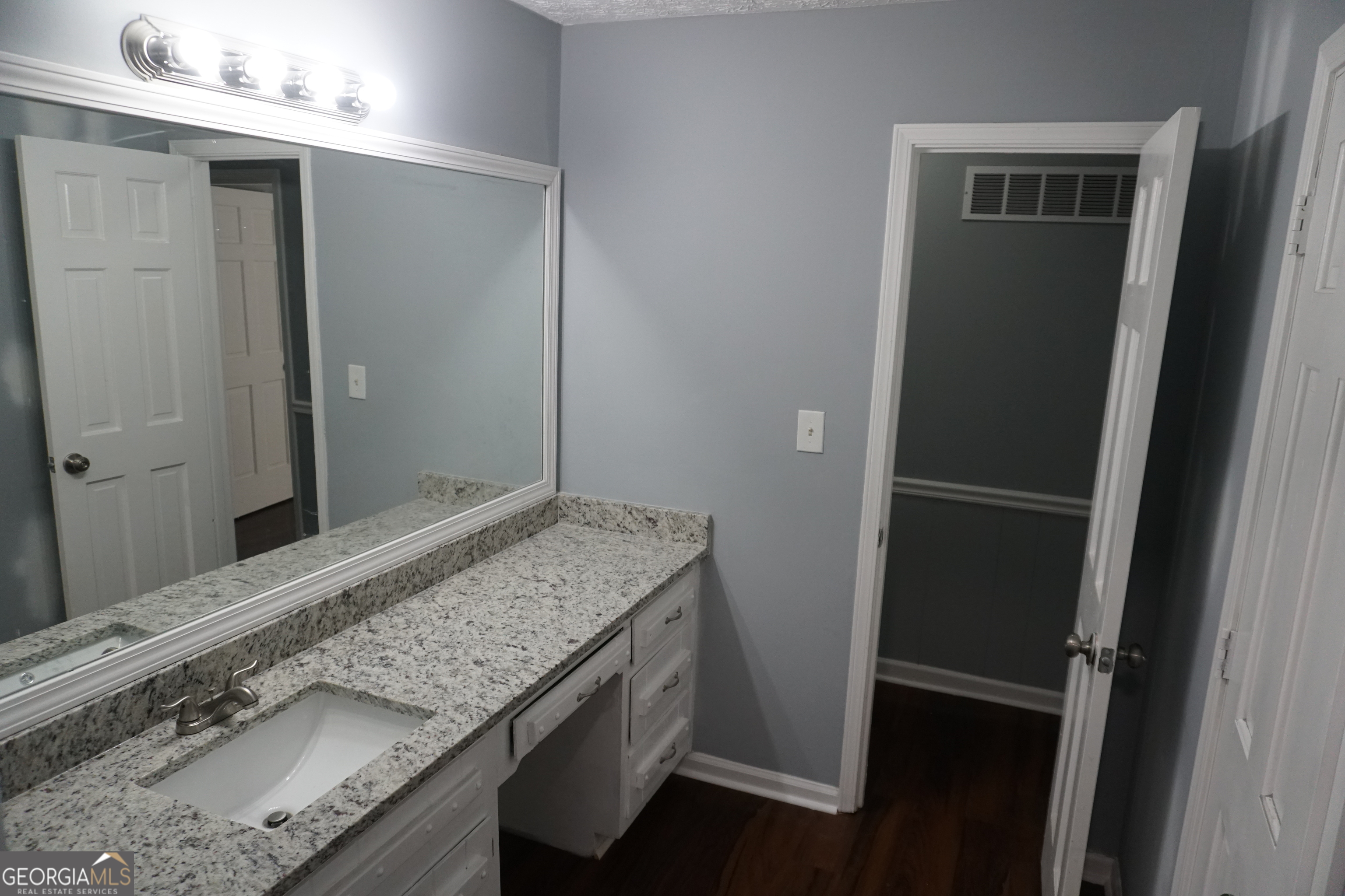 9243 Seminole Road Jonesboro, GA 30236 - Photo 28 of 40 a bathroom with a granite countertop sink and a mirror
