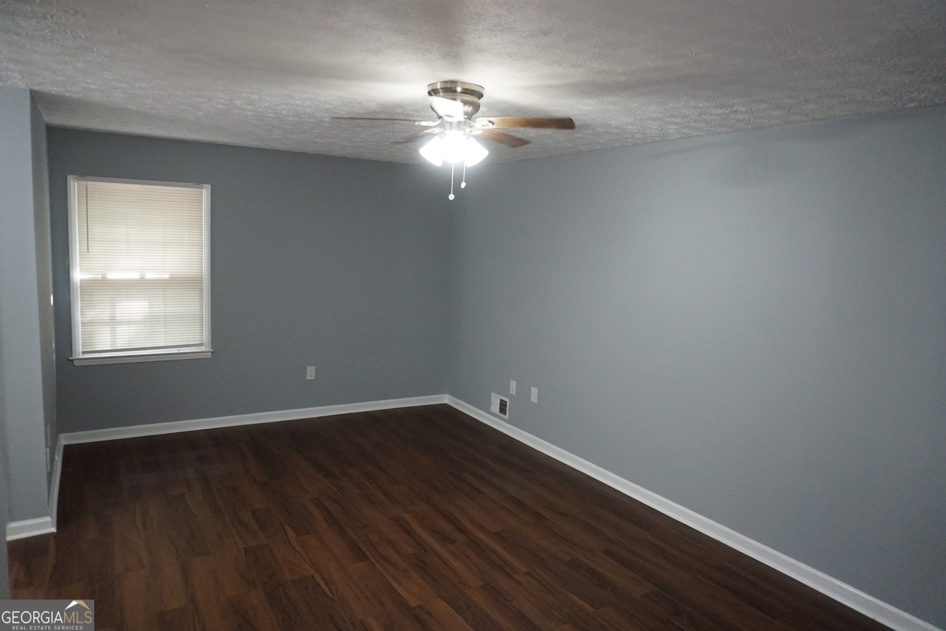 9243 Seminole Road Jonesboro, GA 30236 - Photo 31 of 40 a view of wooden floor and chandelier fan in a room