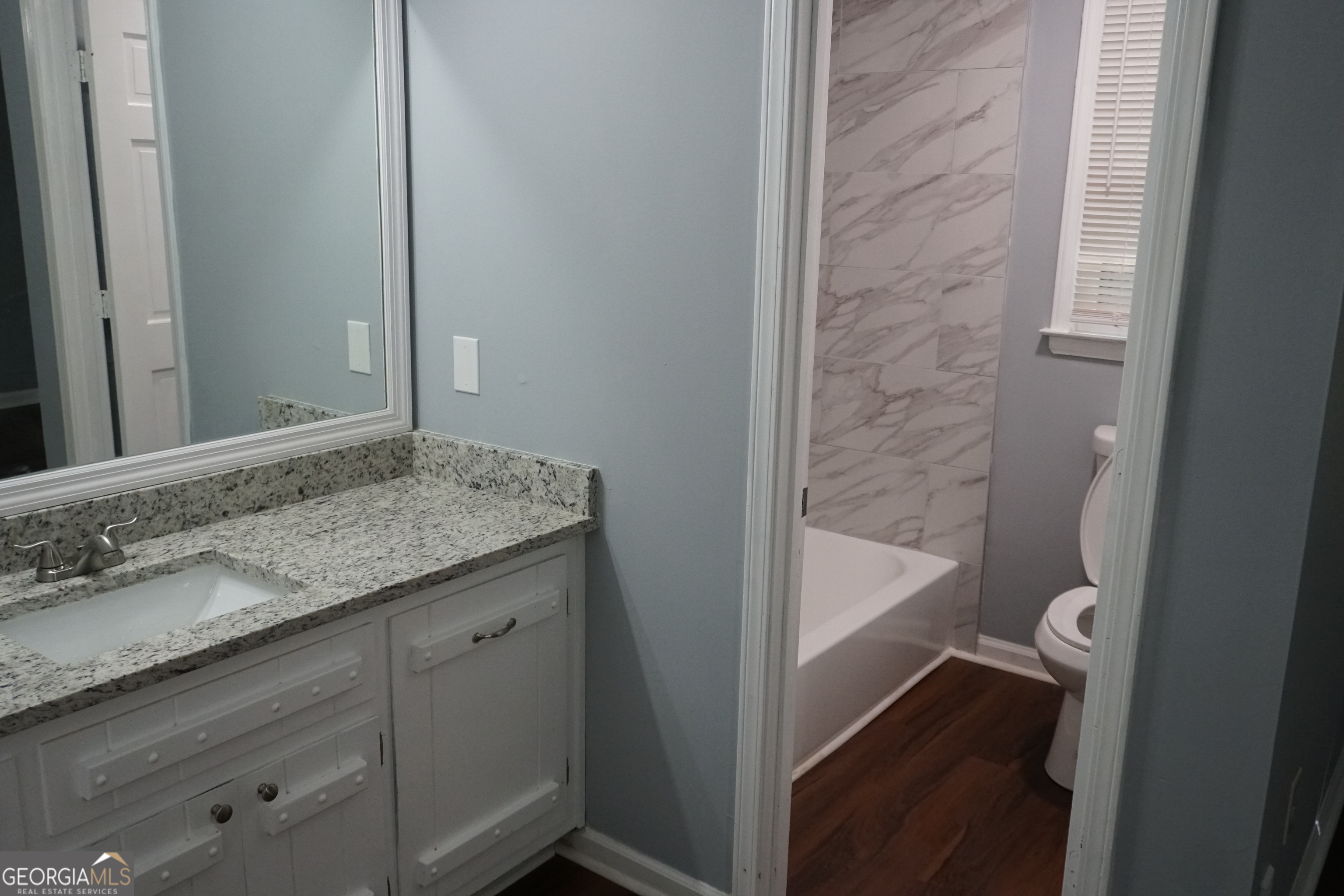 9243 Seminole Road Jonesboro, GA 30236 - Photo 32 of 40 a bathroom with a granite countertop sink toilet and shower