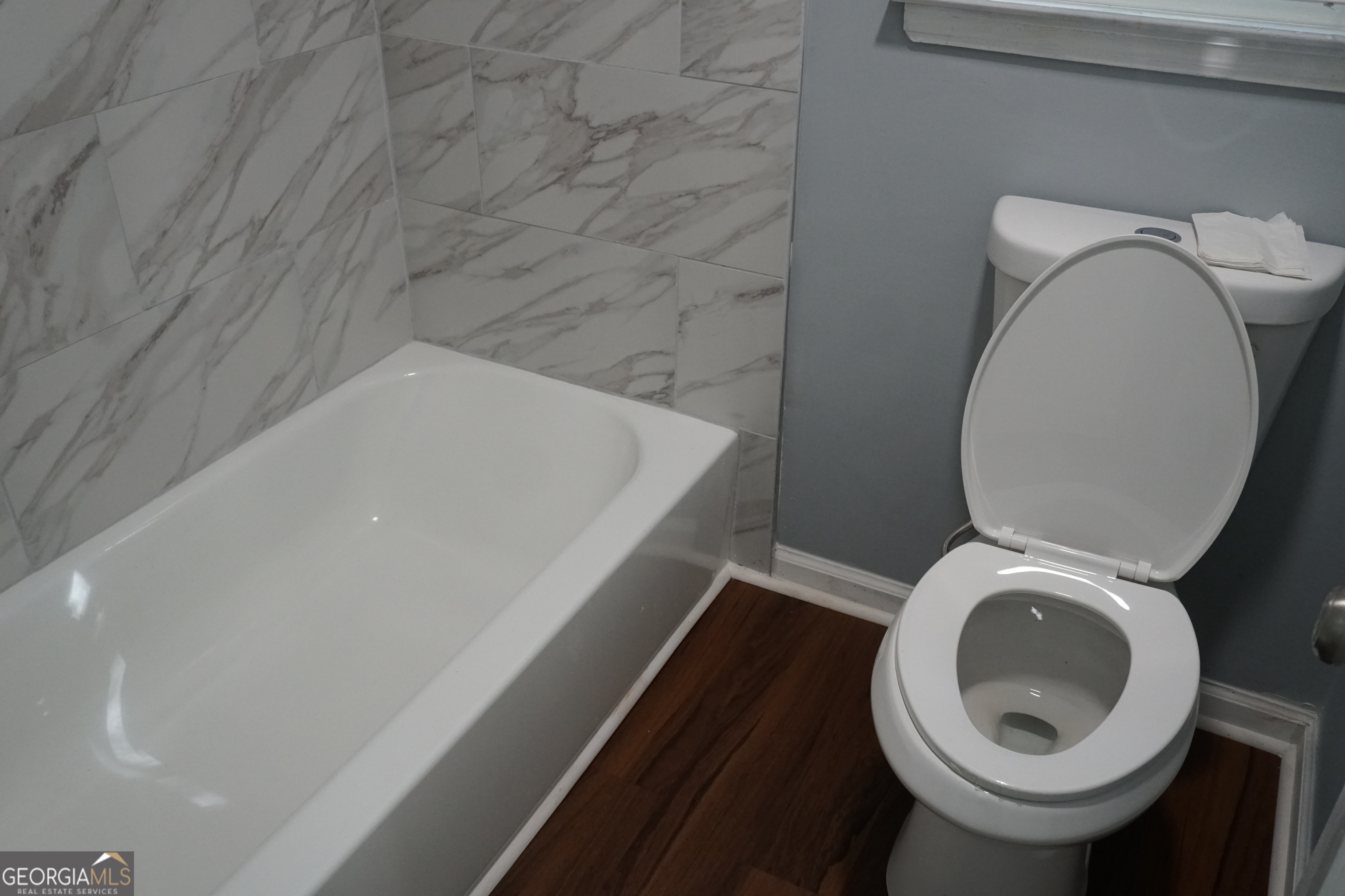 9243 Seminole Road Jonesboro, GA 30236 - Photo 33 of 40 a bathroom with a toilet and a sink