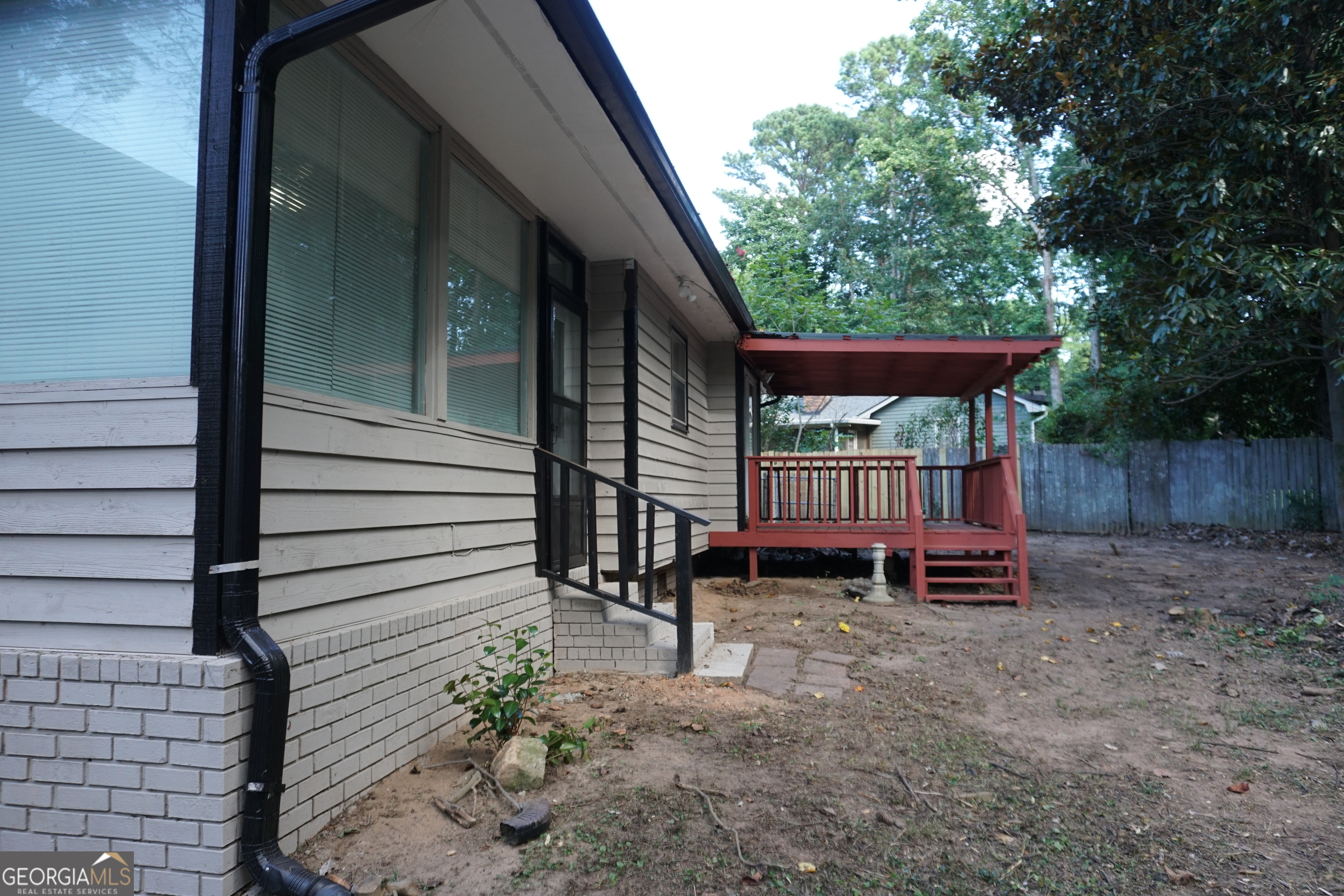 9243 Seminole Road Jonesboro, GA 30236 - Photo 38 of 40 a backyard of a house with barbeque oven and table and chairs