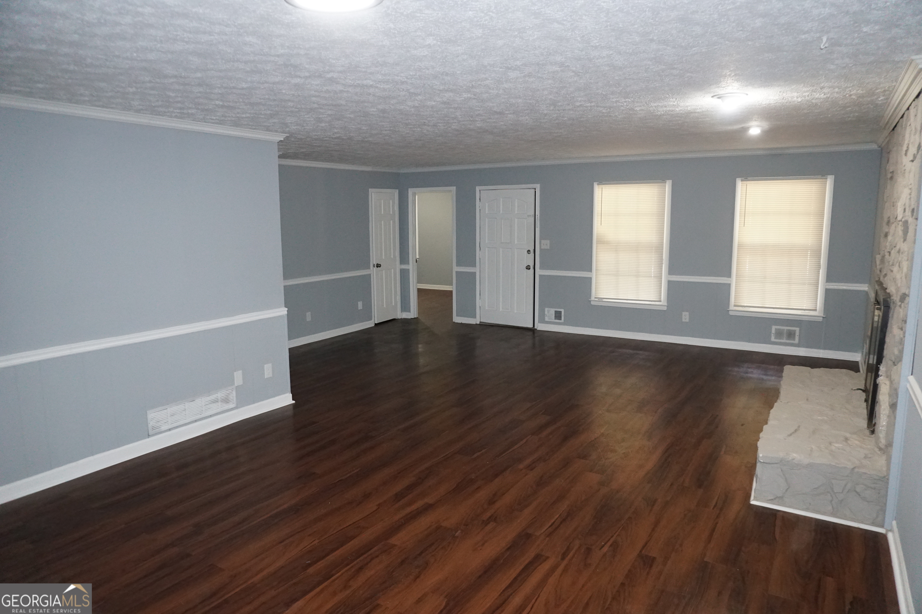 9243 Seminole Road Jonesboro, GA 30236 - Photo 5 of 40 an empty room with wooden floor and windows
