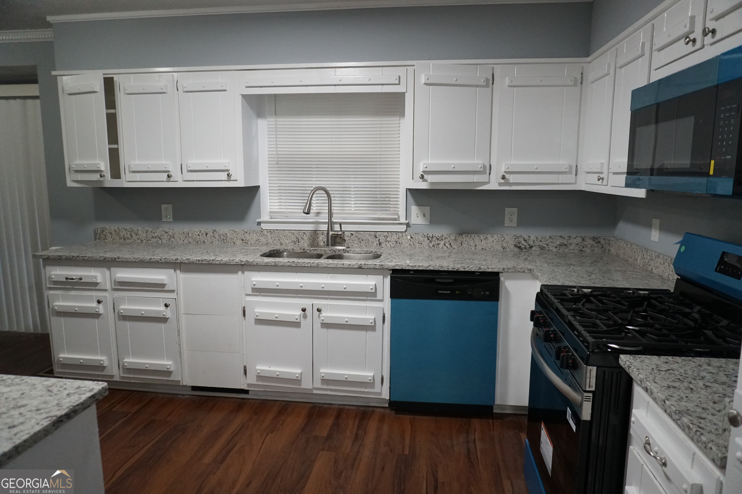 9243 Seminole Road Jonesboro, GA 30236 - Photo 7 of 40 a kitchen with stainless steel appliances granite countertop a sink stove and cabinets