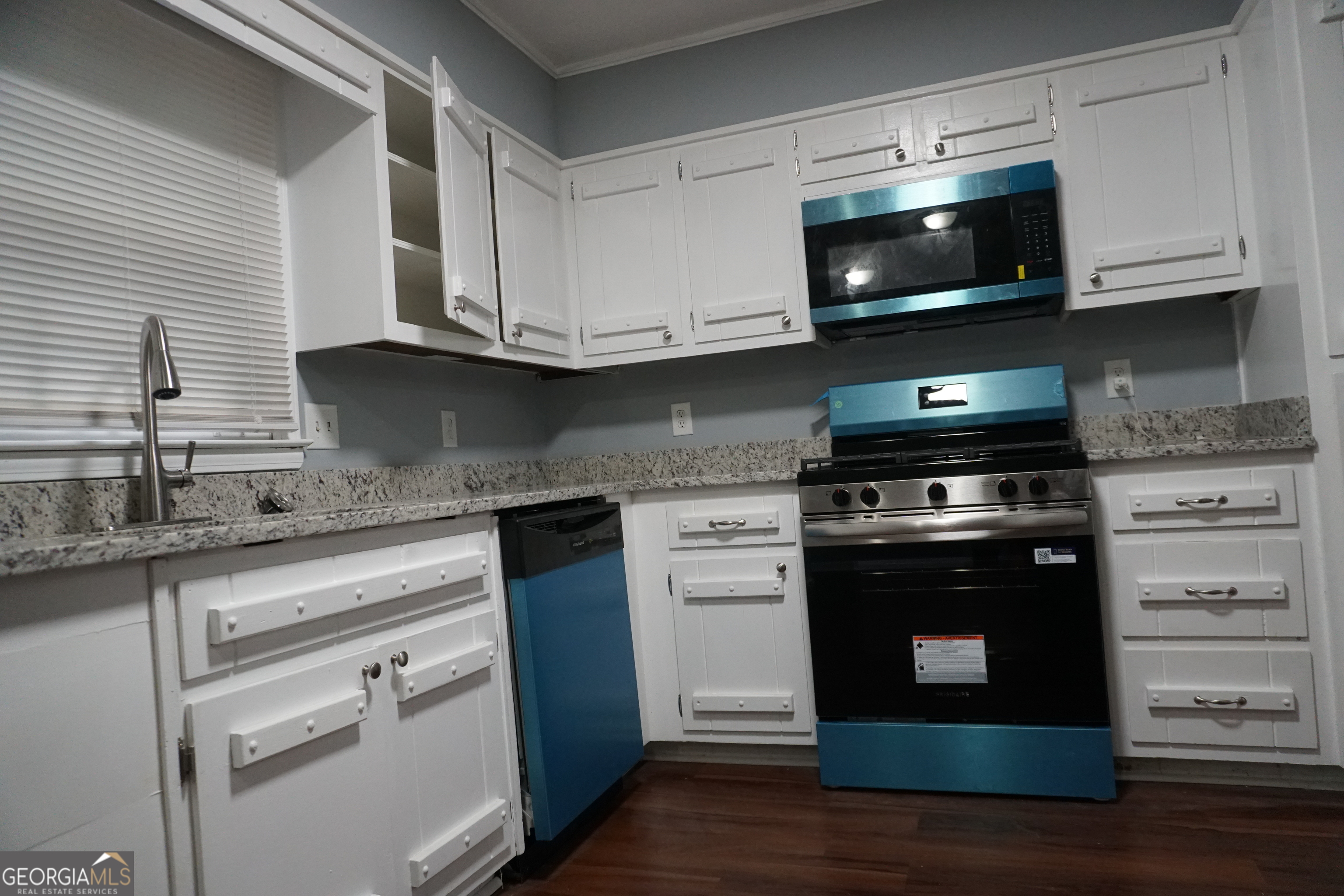 9243 Seminole Road Jonesboro, GA 30236 - Photo 8 of 40 a kitchen with stainless steel appliances granite countertop a stove and a microwave