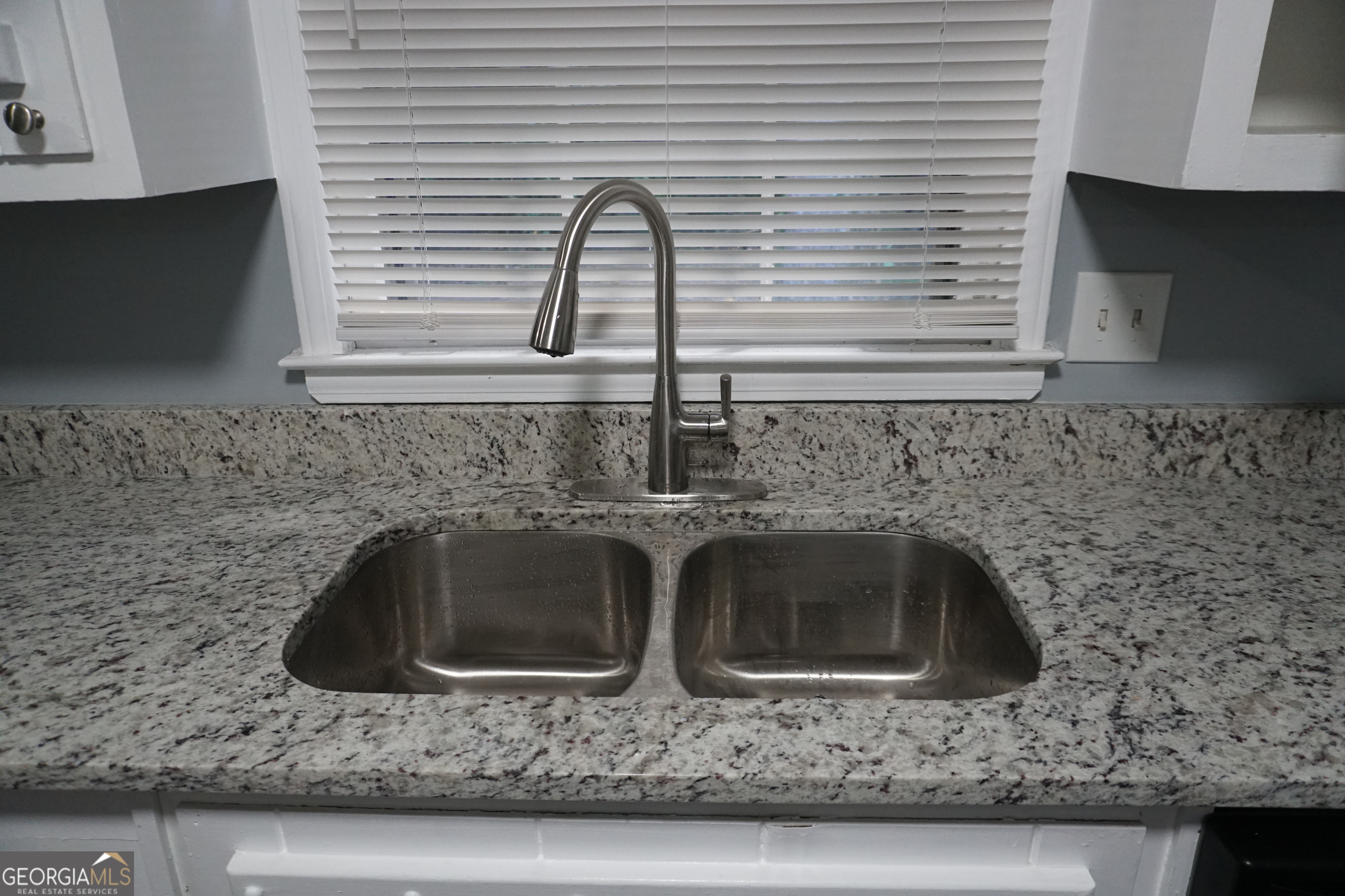 9243 Seminole Road Jonesboro, GA 30236 - Photo 10 of 40 a kitchen with granite countertop a sink and a stove