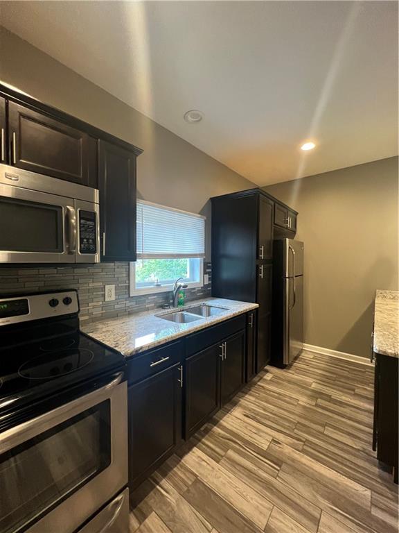 1105 Riverside Drive, Unit 2 Beaver, PA 15009 - Photo 8 of 21 a kitchen with stainless steel appliances granite countertop a sink stove and refrigerator