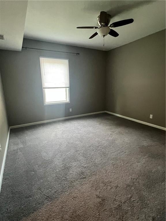 1105 Riverside Drive, Unit 2 Beaver, PA 15009 - Photo 9 of 21 an empty room with a chandelier fan and windows