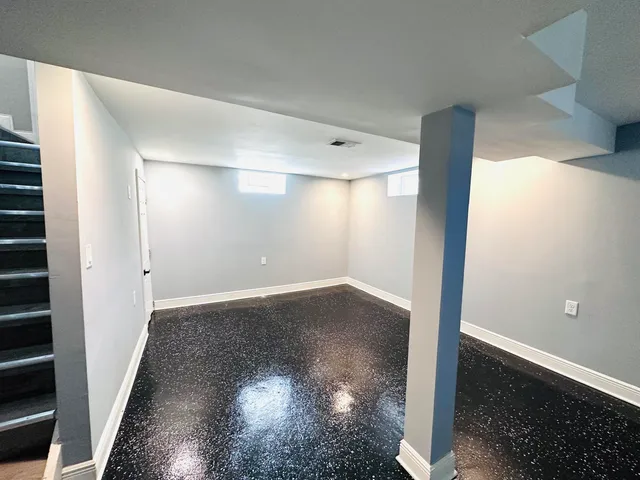 an empty room with wooden floor and closet