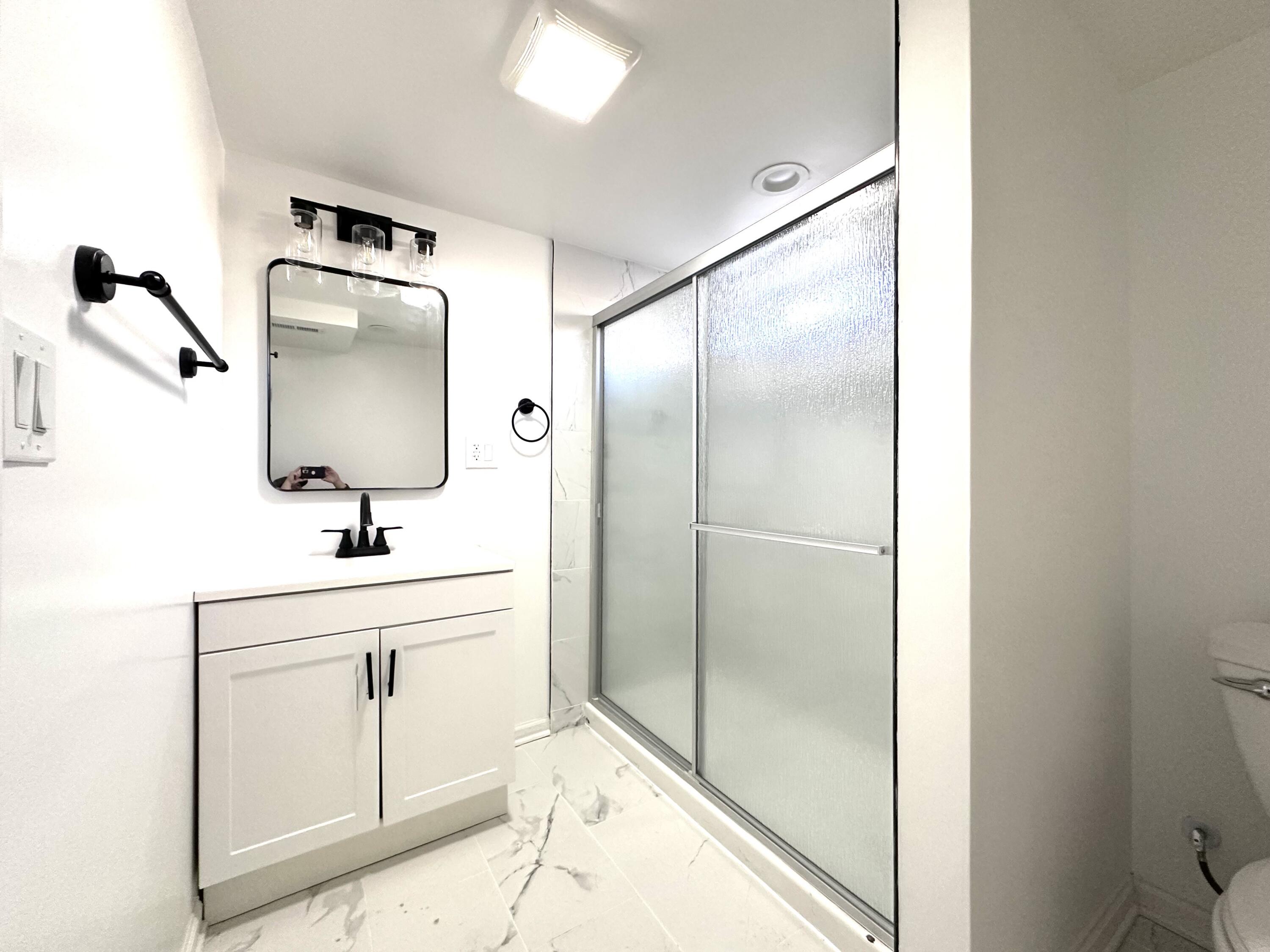 200 Taft Place Gary, IN 46404 - Photo 17 of 18 a bathroom with a shower sink and mirror