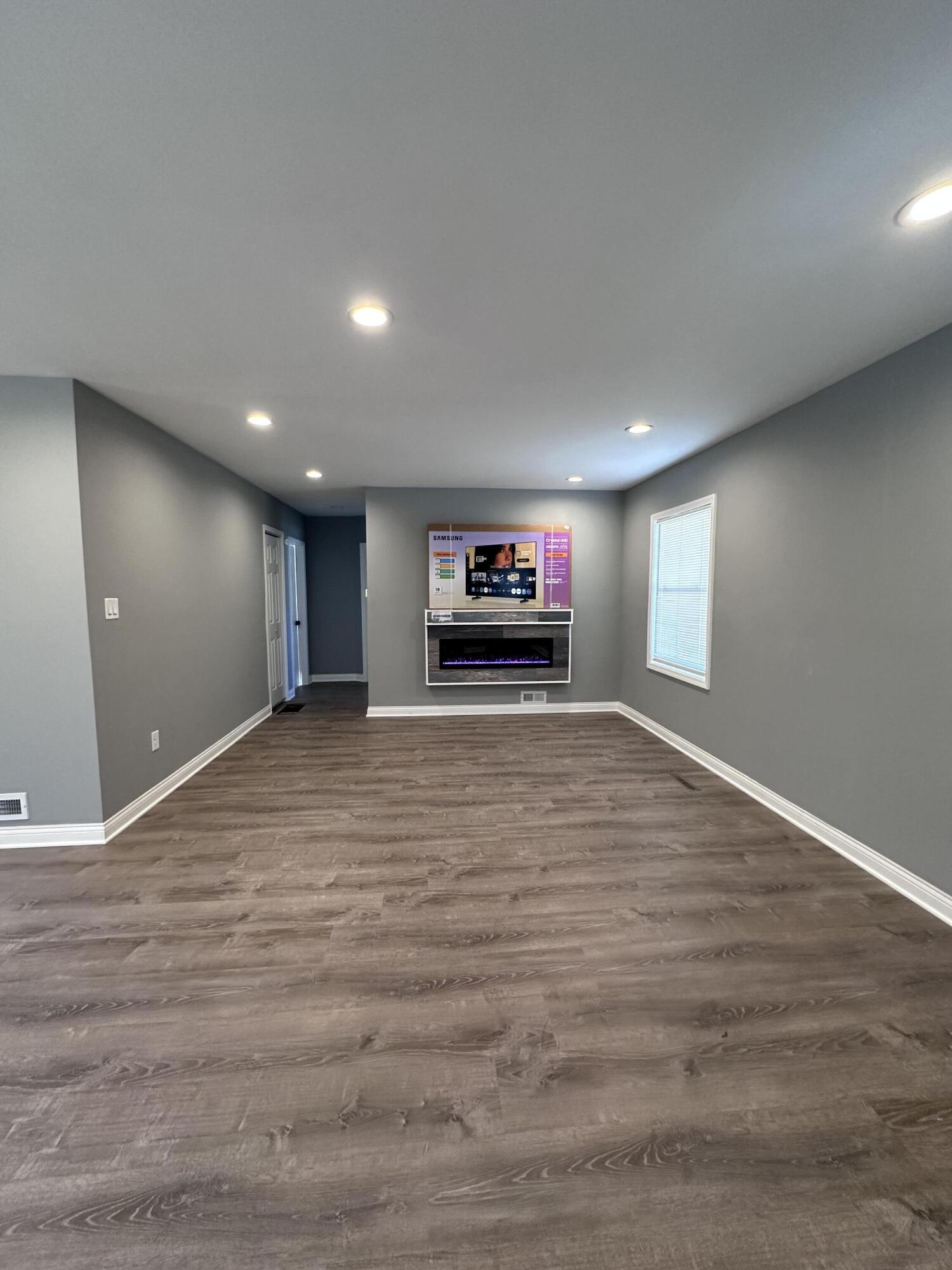 200 Taft Place Gary, IN 46404 - Photo 3 of 18 a view of an empty room with wooden floor and a fireplace