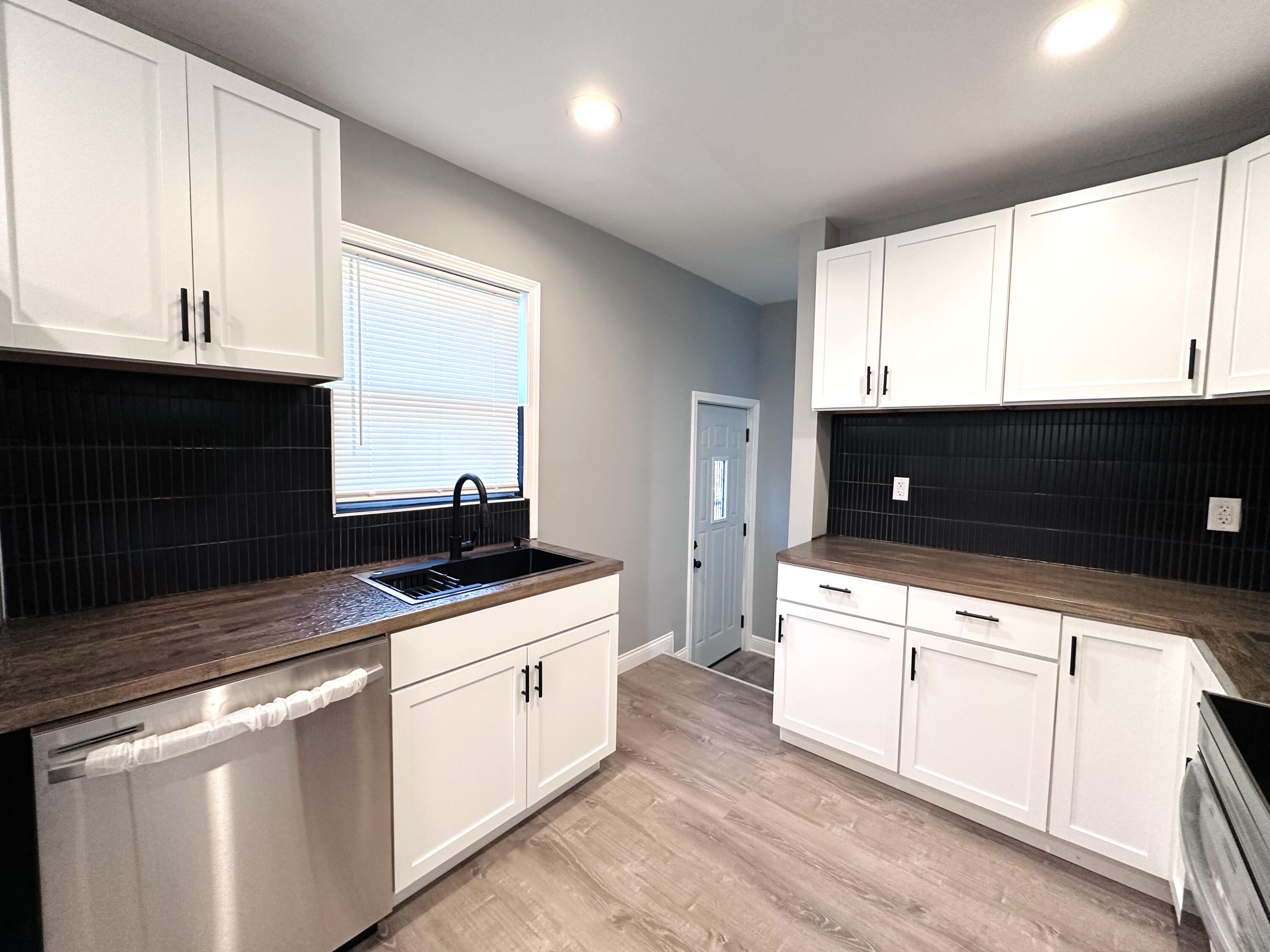 200 Taft Place Gary, IN 46404 - Photo 6 of 18 a kitchen with granite countertop a sink and white cabinets
