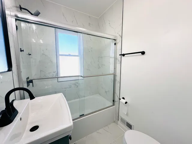 a bathroom with a sink toilet and shower