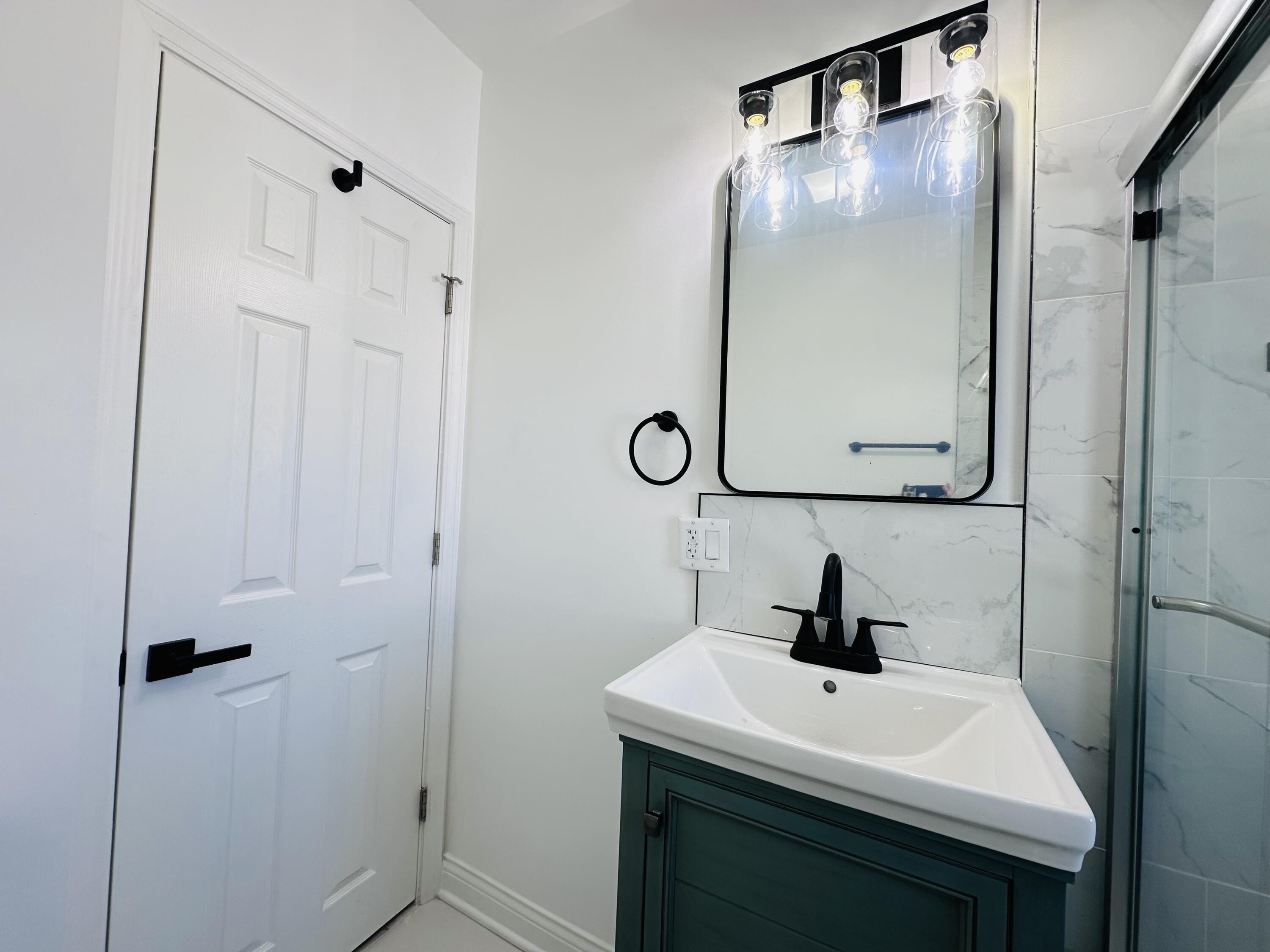 200 Taft Place Gary, IN 46404 - Photo 8 of 18 a bathroom with a sink a mirror and a vanity