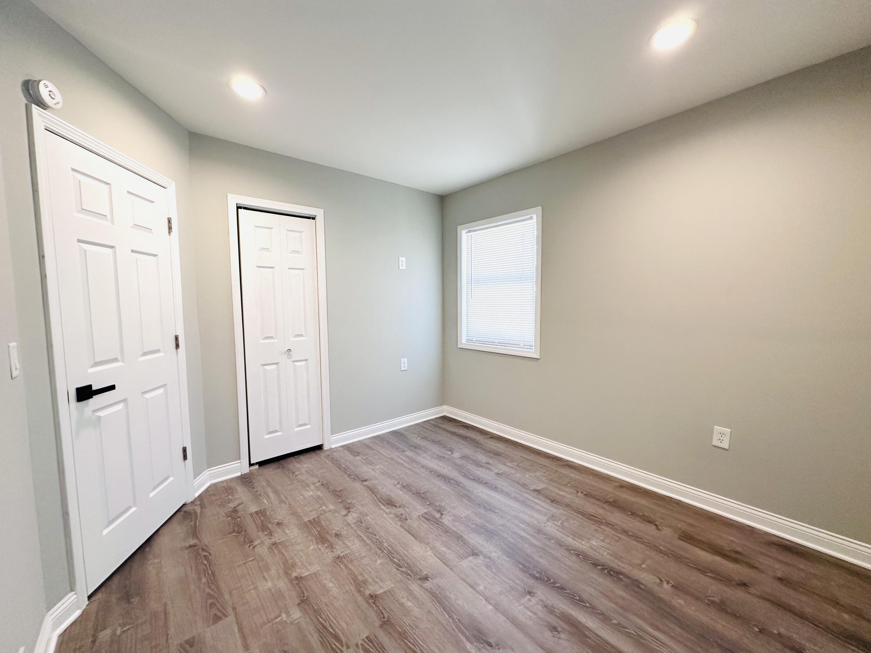 200 Taft Place Gary, IN 46404 - Photo 9 of 18 an empty room with wooden floor and windows