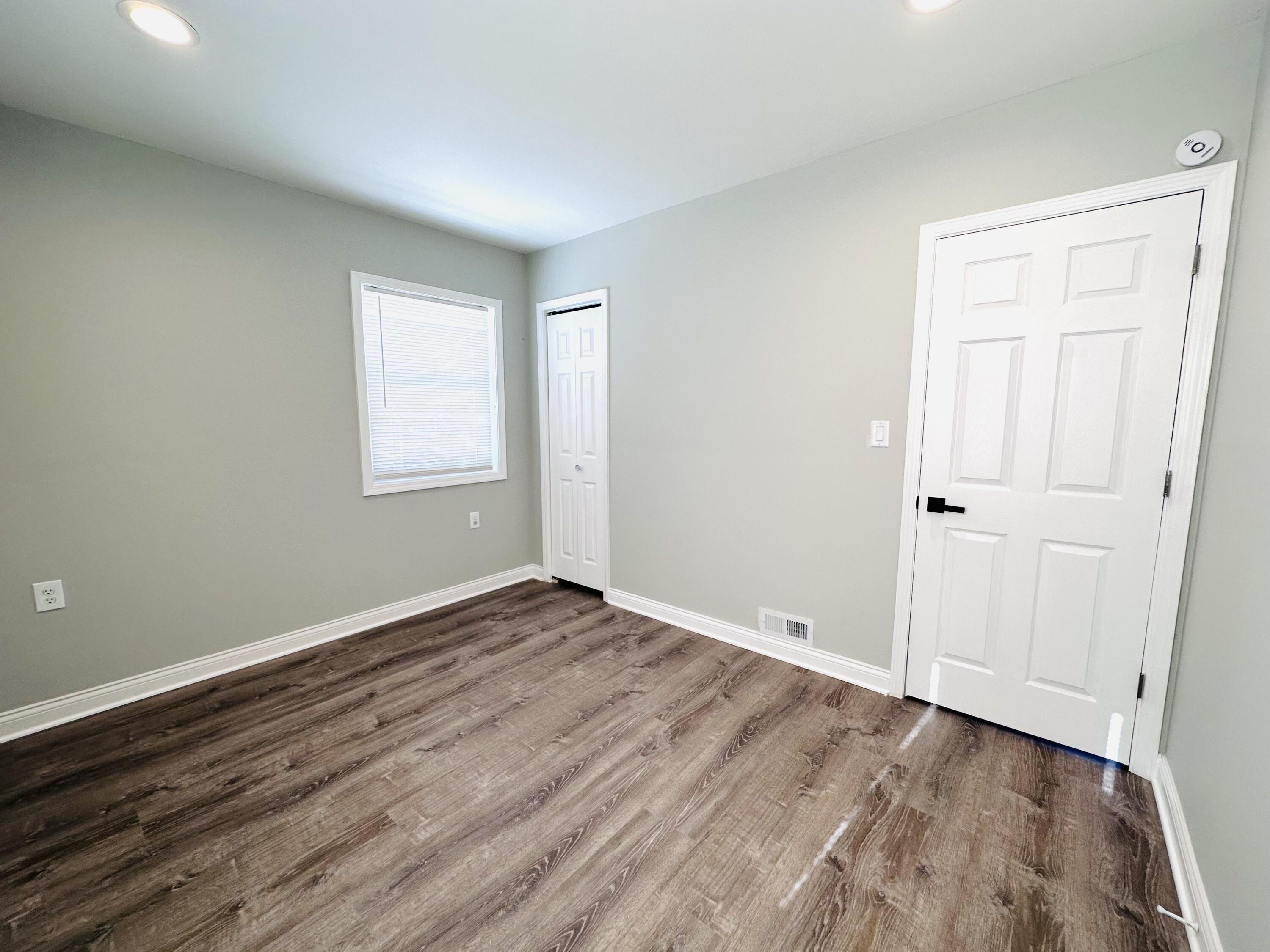 200 Taft Place Gary, IN 46404 - Photo 10 of 18 a view of an empty room with wooden floor and a window