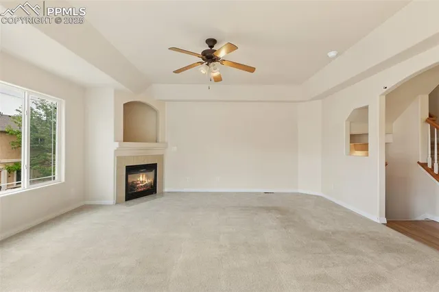 a view of an empty room with a fireplace