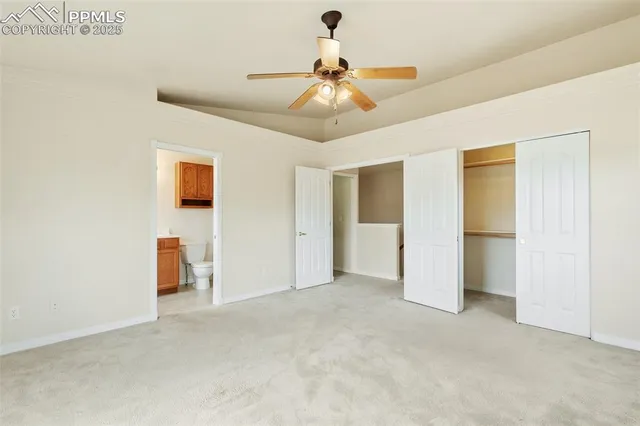 a view of an empty room with a ceiling fan