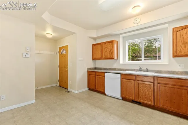 a kitchen with granite countertop a sink and cabinets
