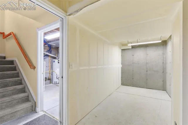 a view of a hallway with wooden floor and entryway