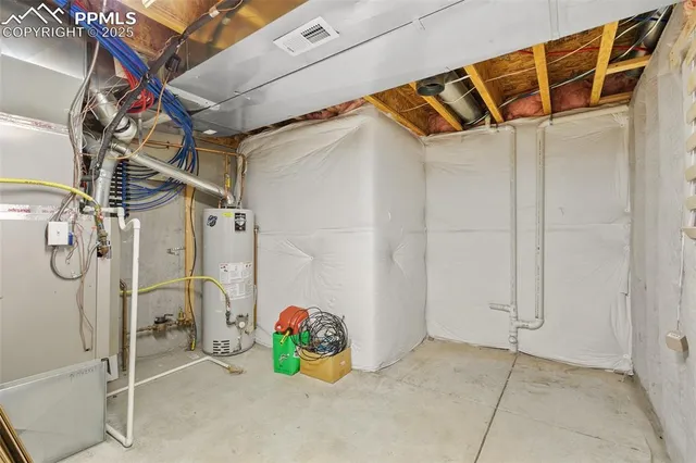 a utility room with a shower and a ceiling fan