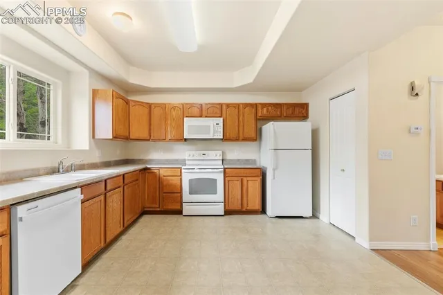 a kitchen with a refrigerator sink stove and cabinets