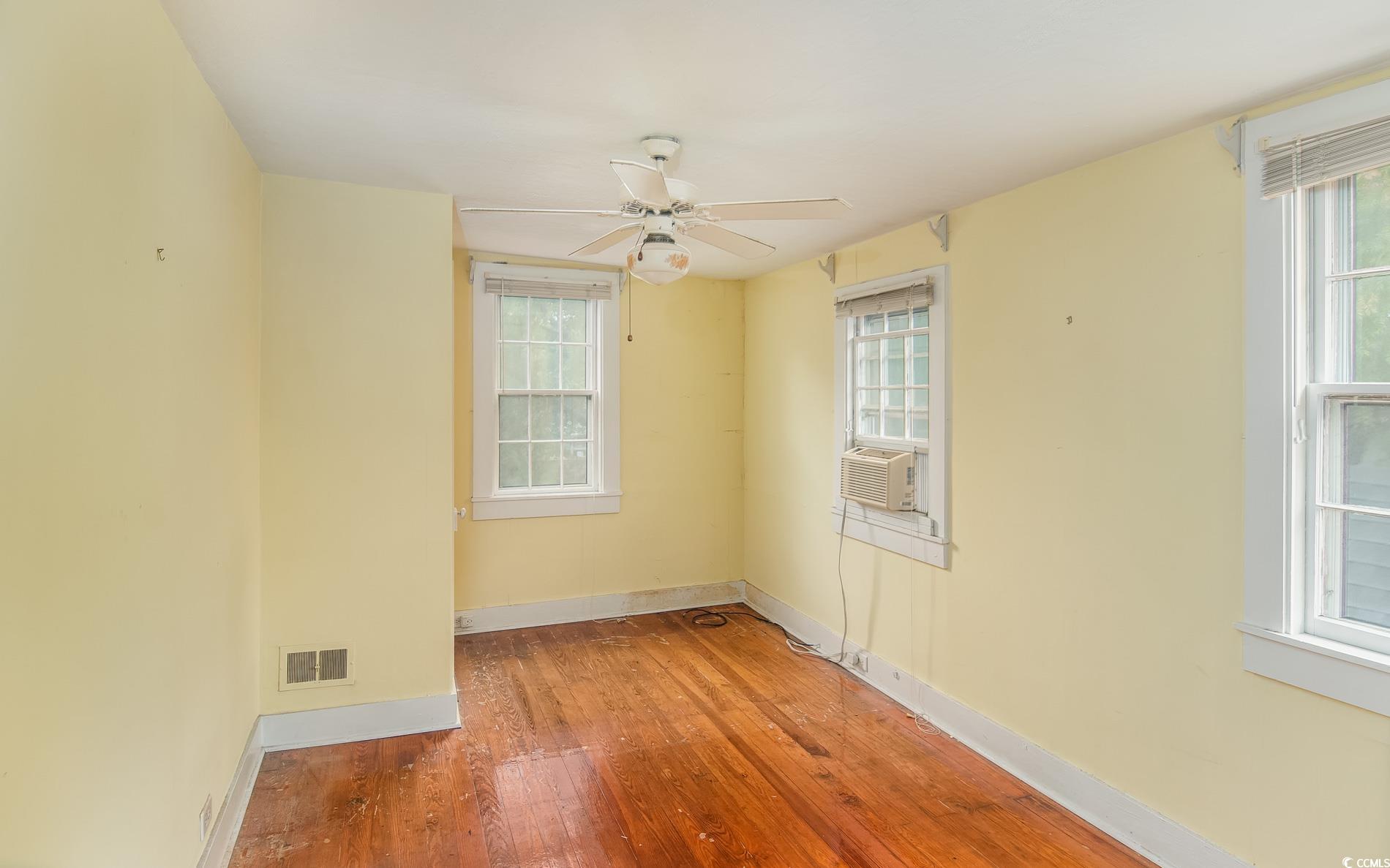 1010 Highmarket Street Georgetown, SC 29440 - Photo 19 of 32 Spare room with hardwood / wood-style floors, plenty of natural light, ceiling fan, and cooling unit