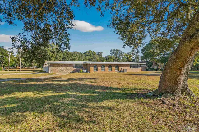 a backyard of a house with lots of green space