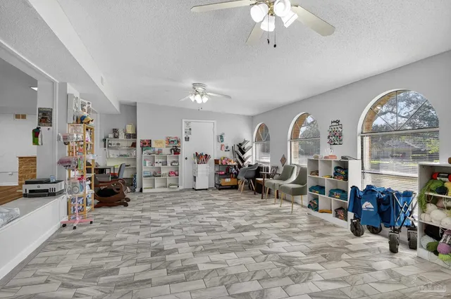 a kitchen with stainless steel appliances granite countertop a stove top oven a sink dishwasher a dining table and chairs with wooden floor