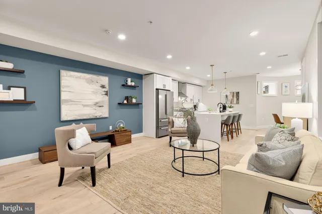 a living room with furniture and kitchen view