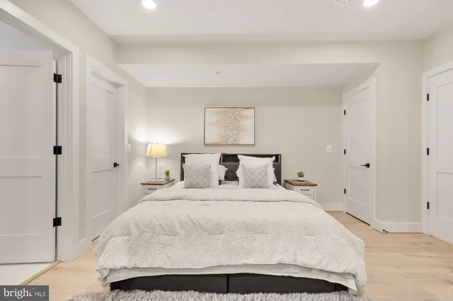 a large white bed in a white room
