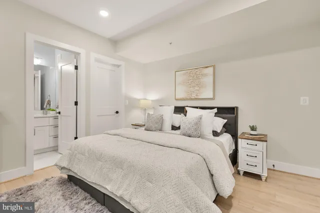 a large bed sitting in a bedroom and a table