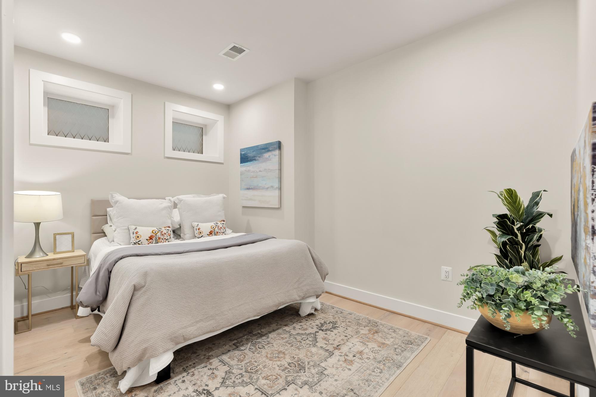 2829 13th Street Northwest, Unit 1 Washington, DC 20009 - Photo 19 of 23 a bedroom with a bed plant and a window