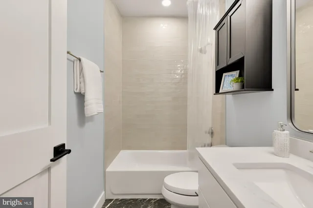 a bathroom with a toilet a sink and bathtub