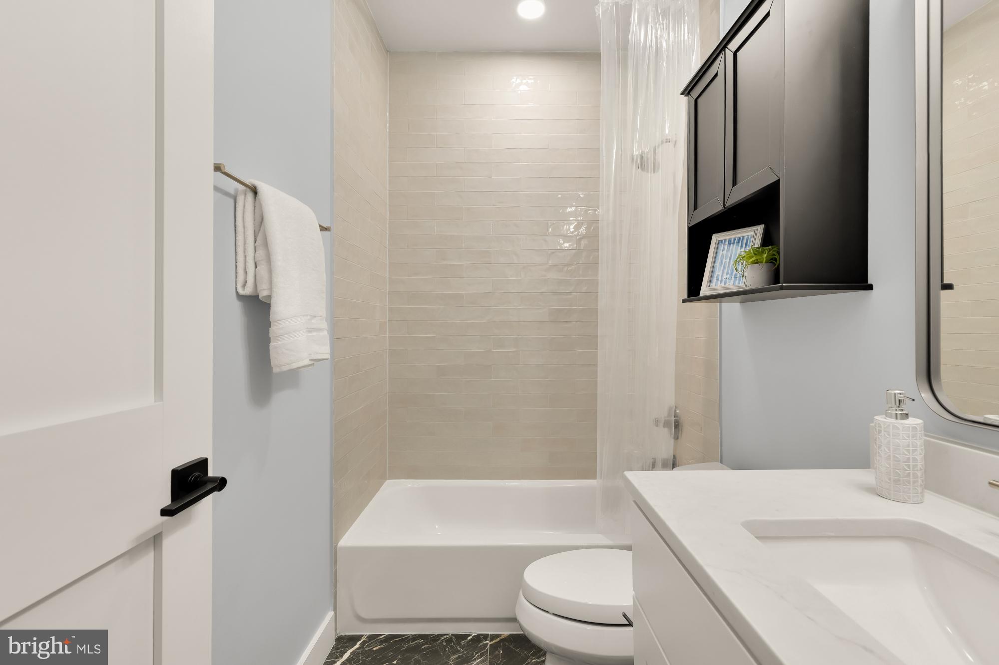 2829 13th Street Northwest, Unit 1 Washington, DC 20009 - Photo 20 of 23 a bathroom with a toilet a sink and bathtub