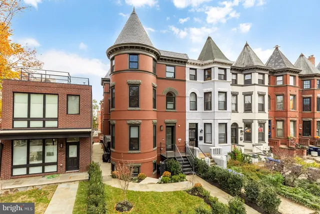 a front view of a residential apartment building with a yard