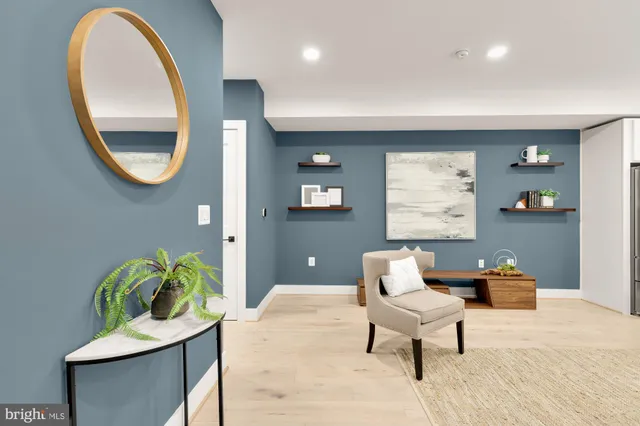 a living room with furniture and a mirror