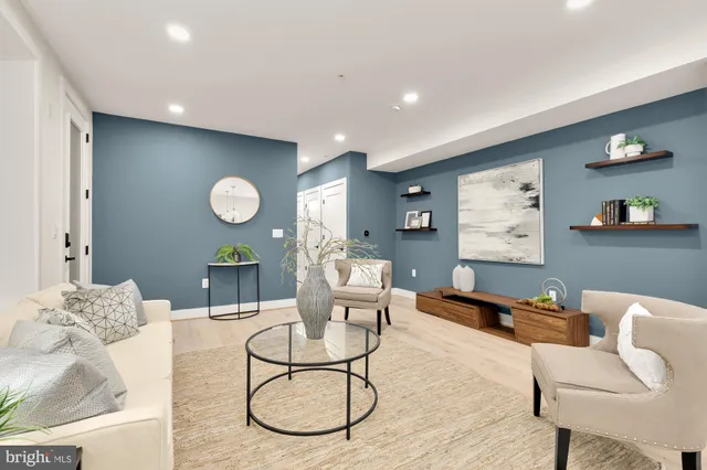 a living room with furniture and a large mirror