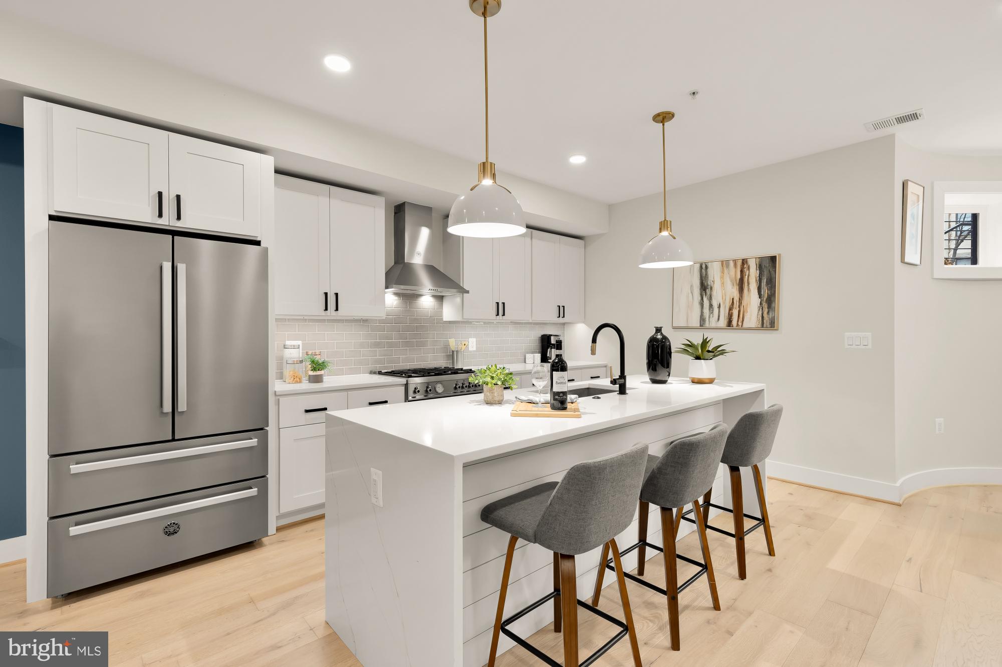 2829 13th Street Northwest, Unit 1 Washington, DC 20009 - Photo 9 of 23 a kitchen with stainless steel appliances a refrigerator a sink a stove a dining table and chairs