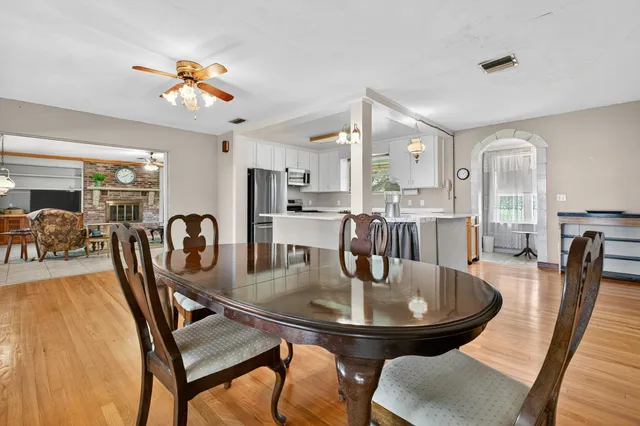 a kitchen with white cabinets and chandelier