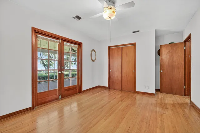 a view of a living room and floor to ceiling window wooden floor