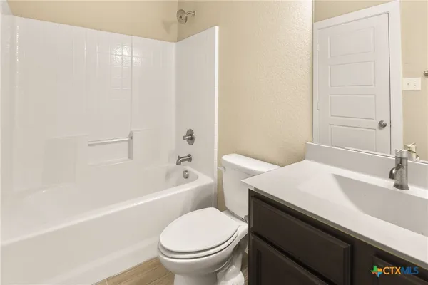 a bathroom with a sink a toilet and a bathtub