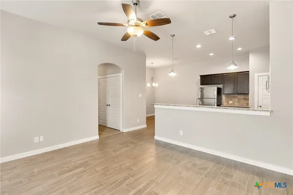 a view of a kitchen with a sink and a ceiling fan